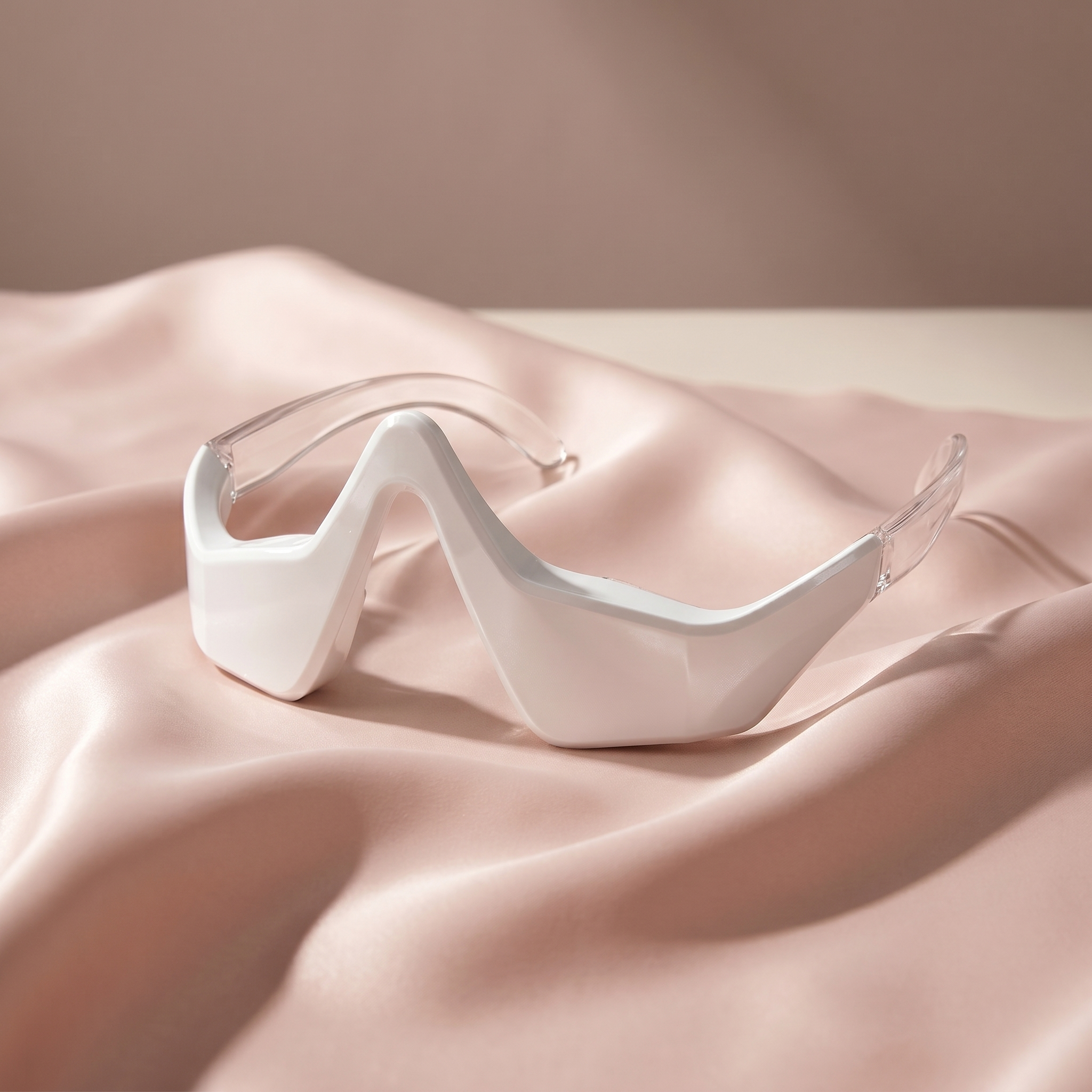Sololume Eye Reviver under-eye red light device on soft blush silk